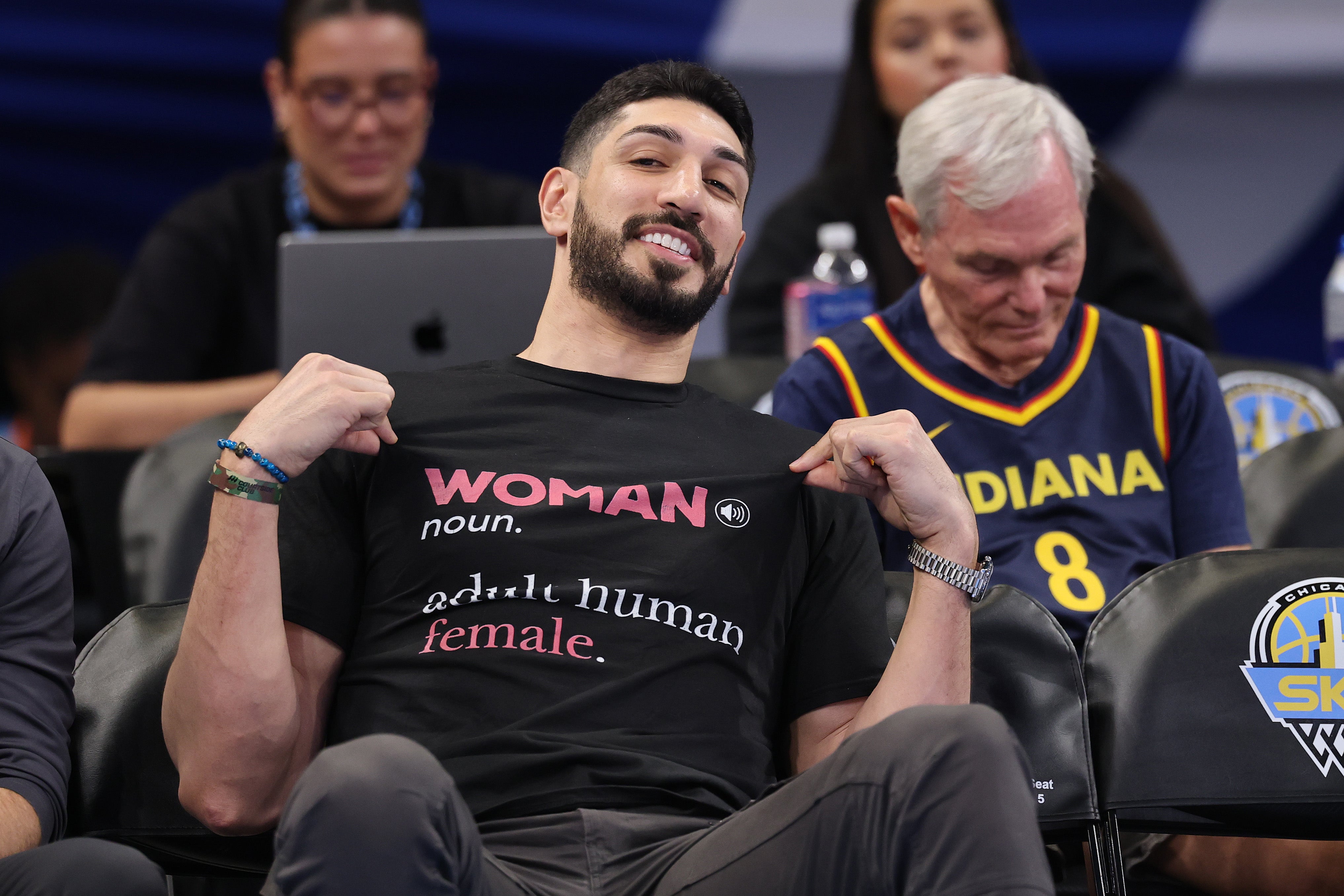 Freedom was sitting along the baseline. He had on a black shirt that read “WOMAN noun. adult human female”