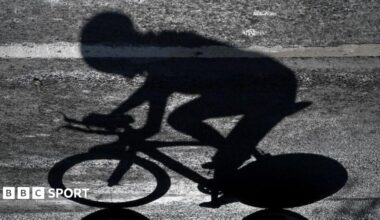 The shadow of a rider who is competing in a professional cycling race