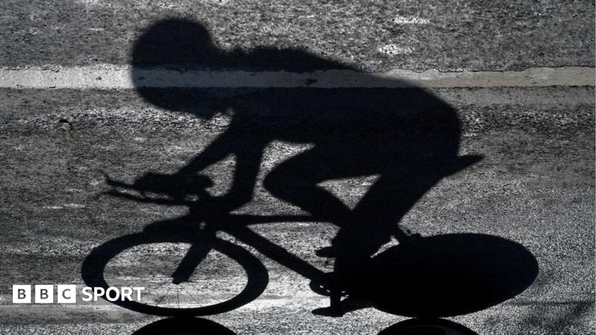 The shadow of a rider who is competing in a professional cycling race