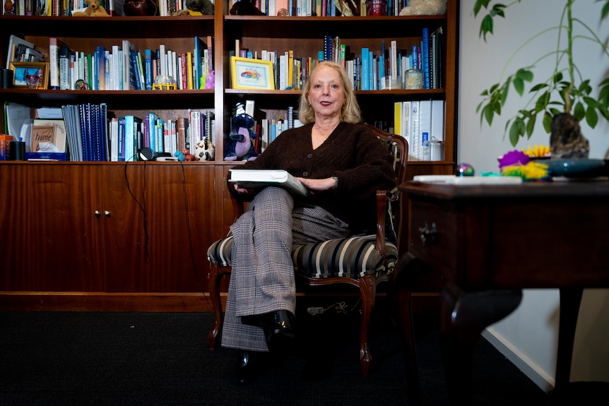 A woman sitting in a chair in an office.