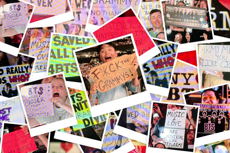 Fans holding signs expressing their support for BTS and criticism of the Grammys during a lively event. Fans holding signs expressing their support for BTS and criticism of the Grammys during a lively event.