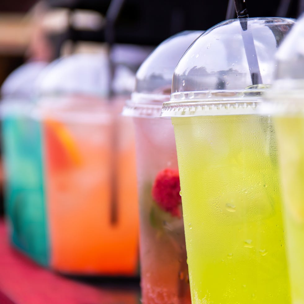 Refreshing multicolour drinks lemonade in glasses with tubules Refreshing multicolour drinks lemonade in glasses with tubules