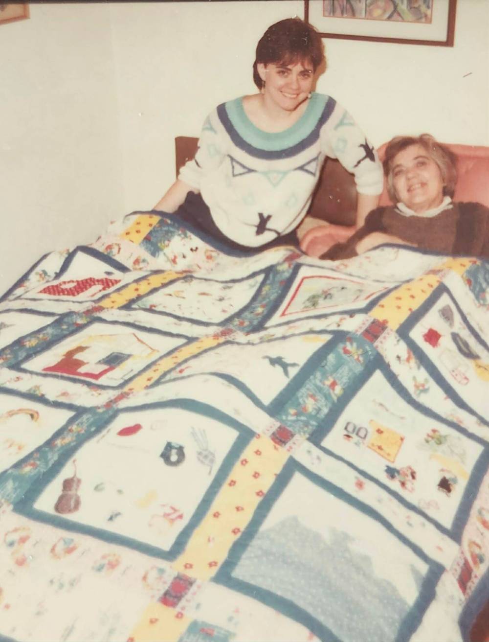 Submitted
Karen (left) with her mother, Norma, and a family quilt Karen crafted as a gift for her.