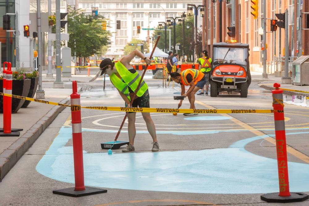 MIKE DEAL / FREE PRESS FILES
Artists create the murals at the start of the project in 2025. Today, some of the painting is getting replaced, as expected for outdoor art, an artist says.