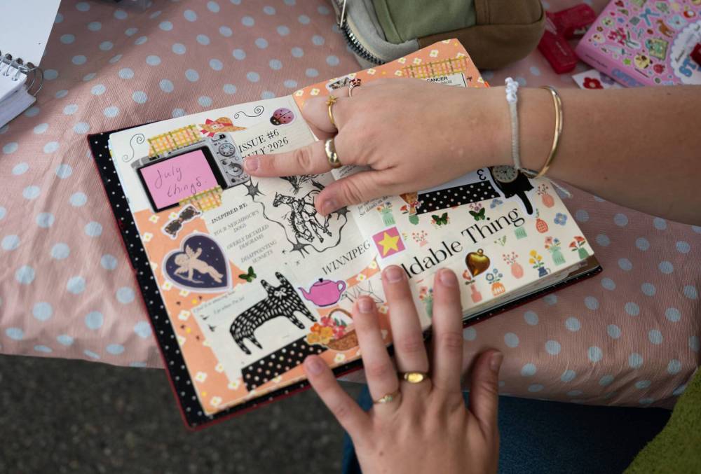 ROBERT LEE / FREE PRESS
Borgfjord shows off one of her journals at Scrap and Yap at the Riverview market on Monday.