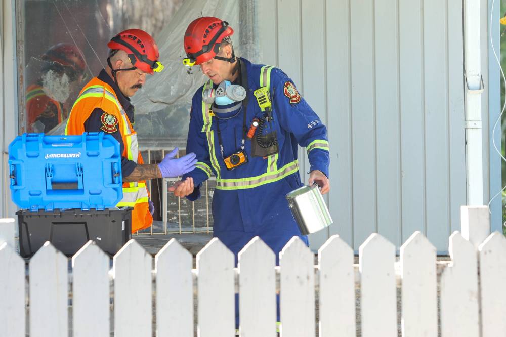 MIKE DEAL / FREE PRESS
Fire investigators at the scene of a house fire at 344 St. Johns Avenue.