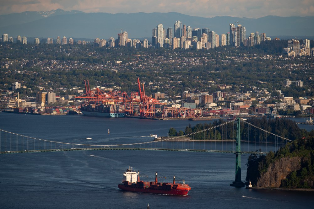 A container ship passes under the Lions Gate Bridge after leaving port, in Vancouver, Monday, May 18, 2020. THE CANADIAN PRESS/Darryl Dyck