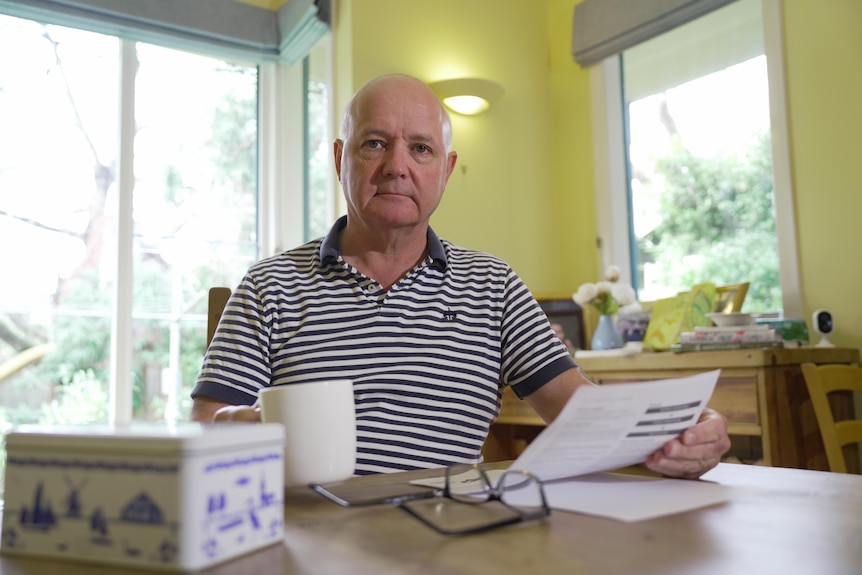 An older man at his kitchen table