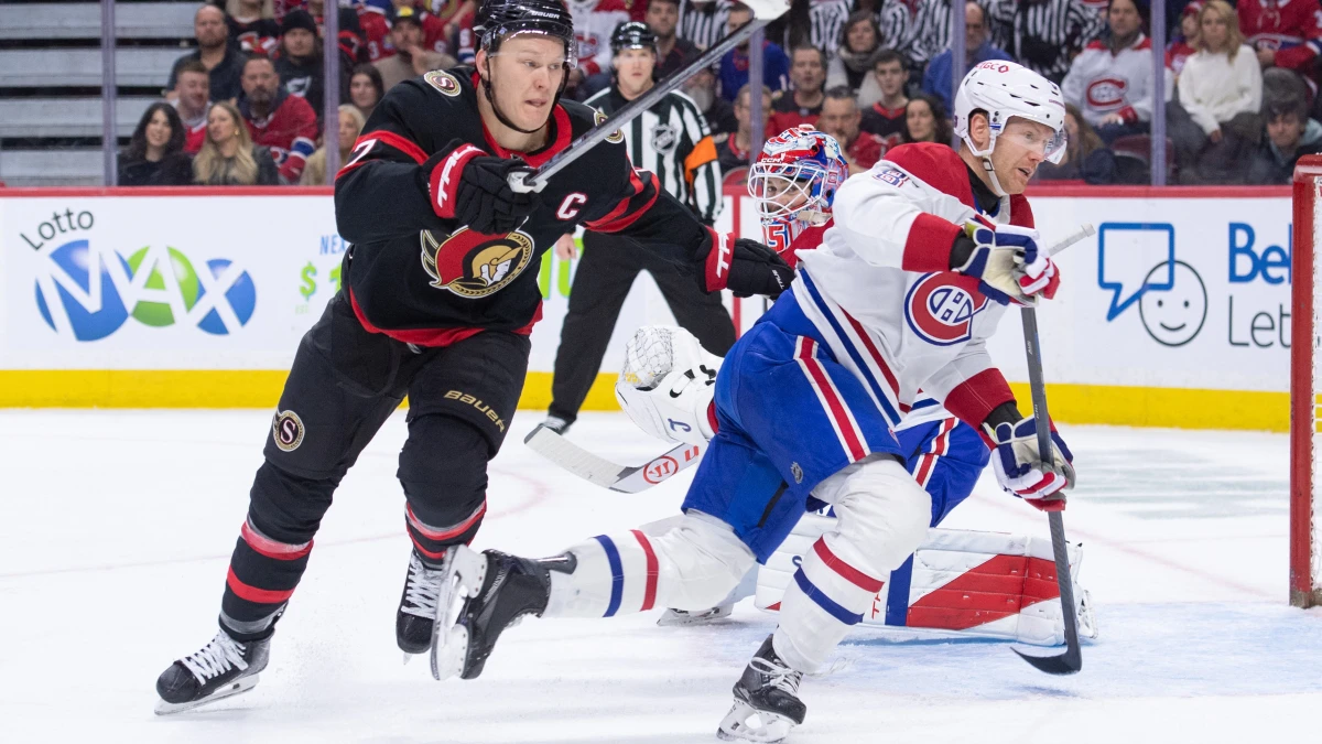 Ottawa Senators left wing Brady Tkachuk (7) and Montreal Canadiens defenseman Mike Matheson (8) chase the puck in the first period at the Canadian Tire Centre.