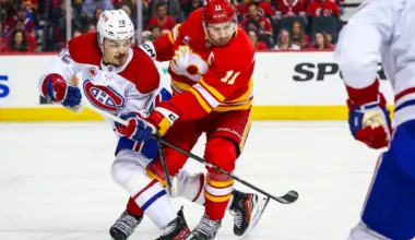 Calgary Flames center Mikael Backlund (11) and Montreal Canadiens defenseman Arber Xhekaj (72) battles for the puck during the second period at Scotiabank Saddledome.