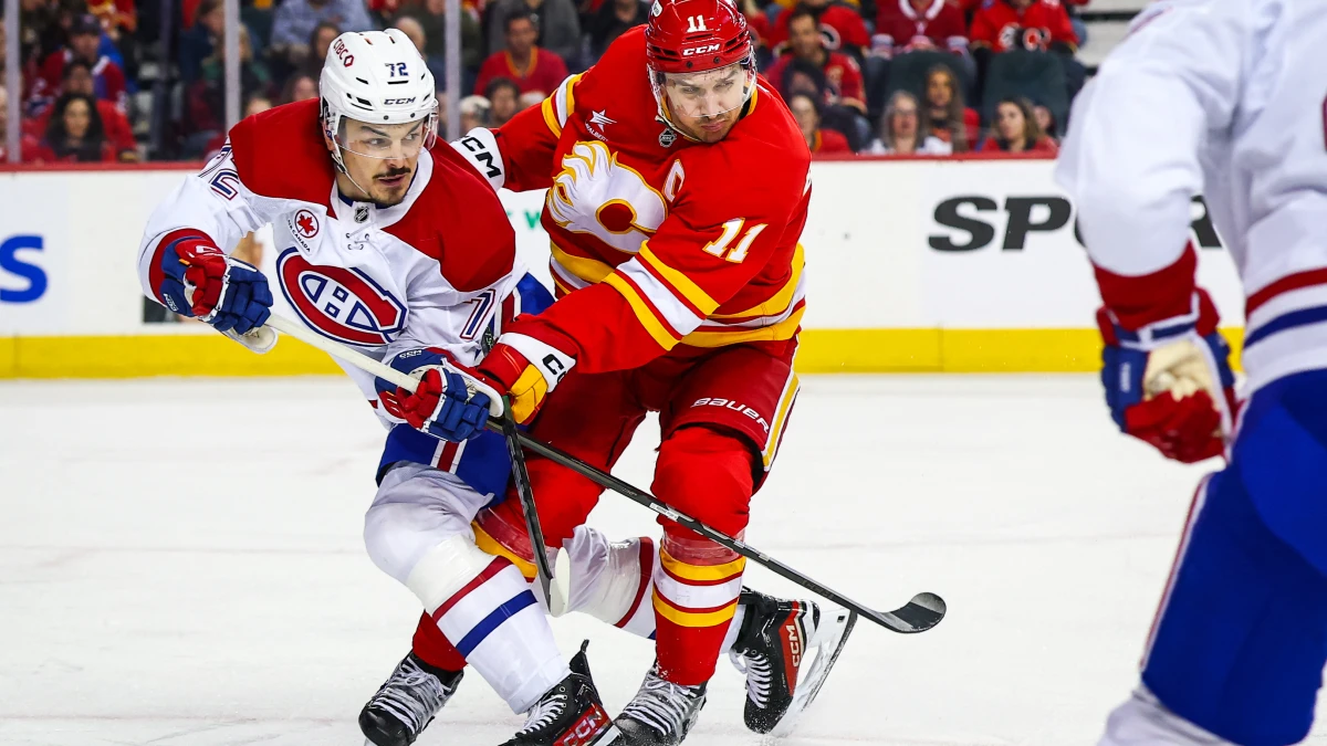 Calgary Flames center Mikael Backlund (11) and Montreal Canadiens defenseman Arber Xhekaj (72) battles for the puck during the second period at Scotiabank Saddledome.