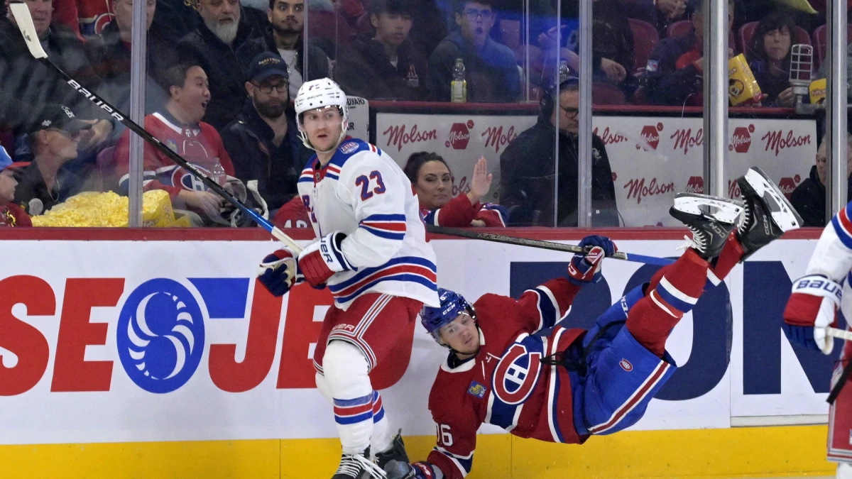 New York Rangers defenseman Adam Fox (23) hits Montreal Canadiens forward Zack Bolduc (76) during the second period at the Bell Centre.