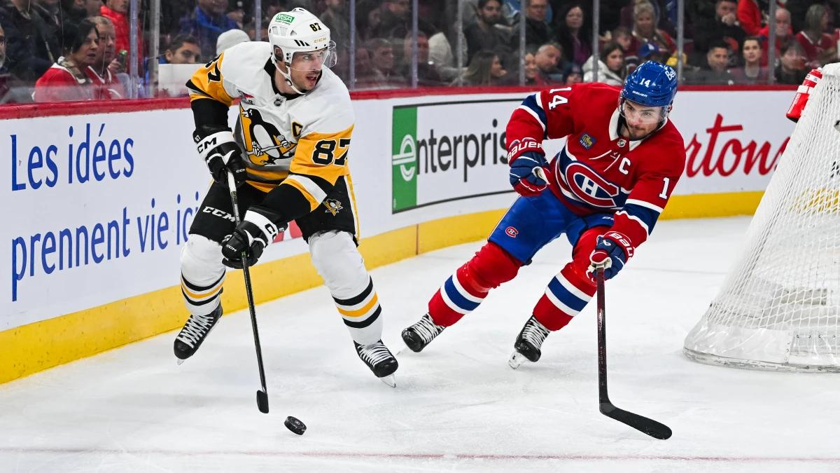 Pittsburgh Penguins center Sidney Crosby (87) plays the puck against Montreal Canadiens center Nick Suzuki (14) during the third period at Bell Centre.