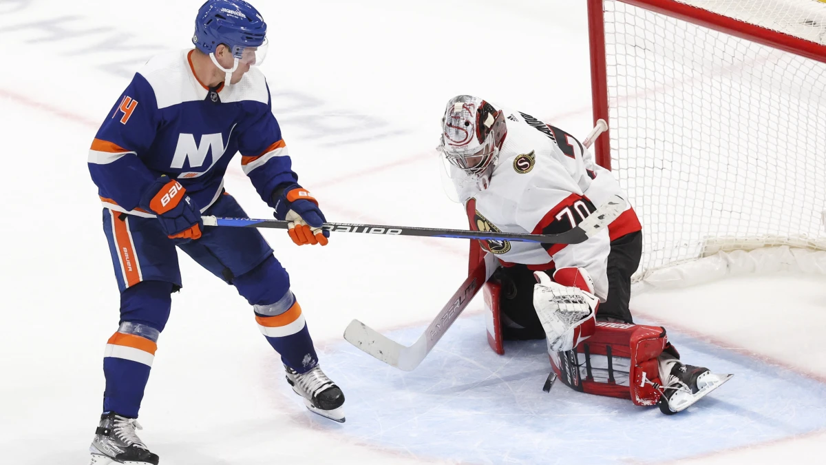 Ottawa Senators goaltender Kevin Mandolese (70) makes a save against New York Islanders center Bo Horvat (14) during overtime at UBS Arena.