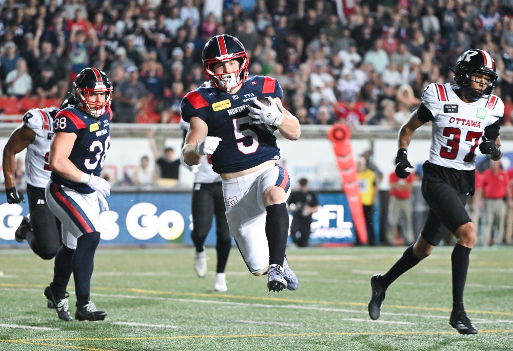 Montreal Alouettes' Travis Theis (5) goes in for a touchdown during second half CFL action against the Ottawa Redblacks in Montreal, on Sunday, June 28, 2026. THE CANADIAN PRESS/Graham Hughes