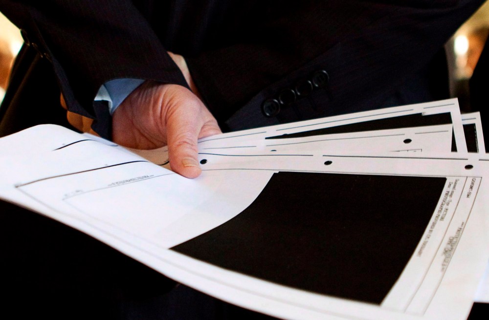 Bob Rae holds redacted pages from an Afghan detainee document in Ottawa in this March 25, 2010 photo. The Canadian Press/Sean Kilpatrick