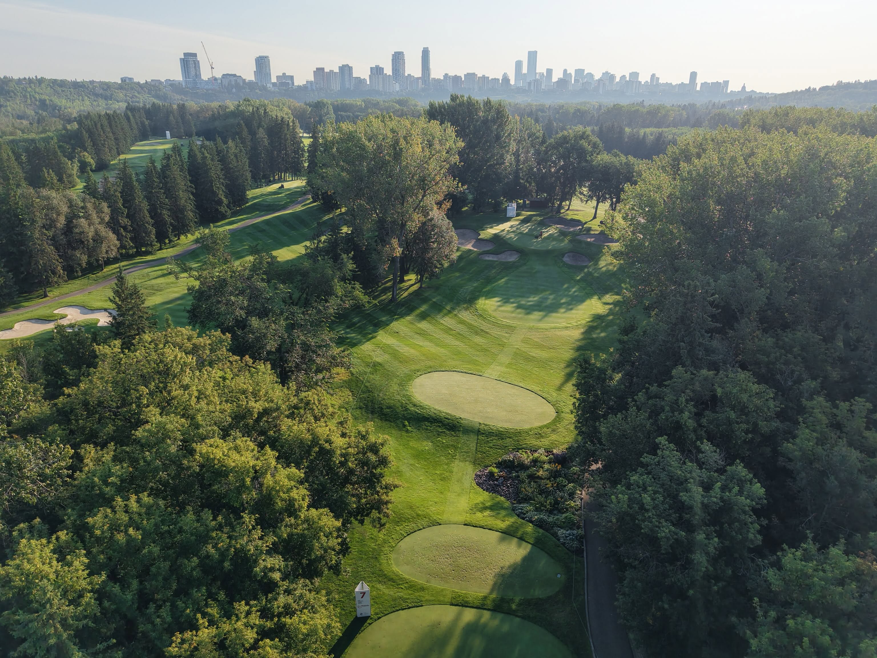 May be an image of golf, grass and golf course
