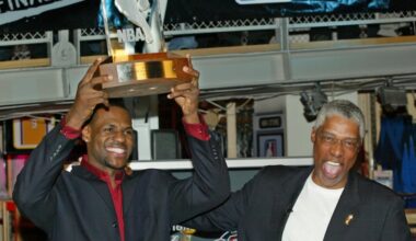 NBA legend Julius 'Dr. J' Erving, right, pats LeBron James on the back after James was officially presented the NBA Rookie of the Year award at the NBA Store on New York's 5th Avenue, April 20, 2004.