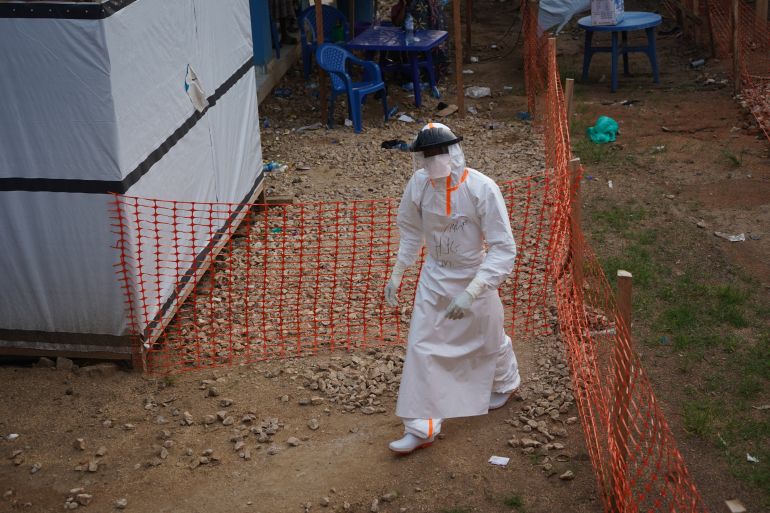 A hygienist works at an Ebola treatment centre in Bunia, Ituri Province, Democratic Republic of the Congo [Prosper Heri Ngorora/Al Jazeera]