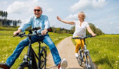 Seniors having fun on bicycles in spring landscape