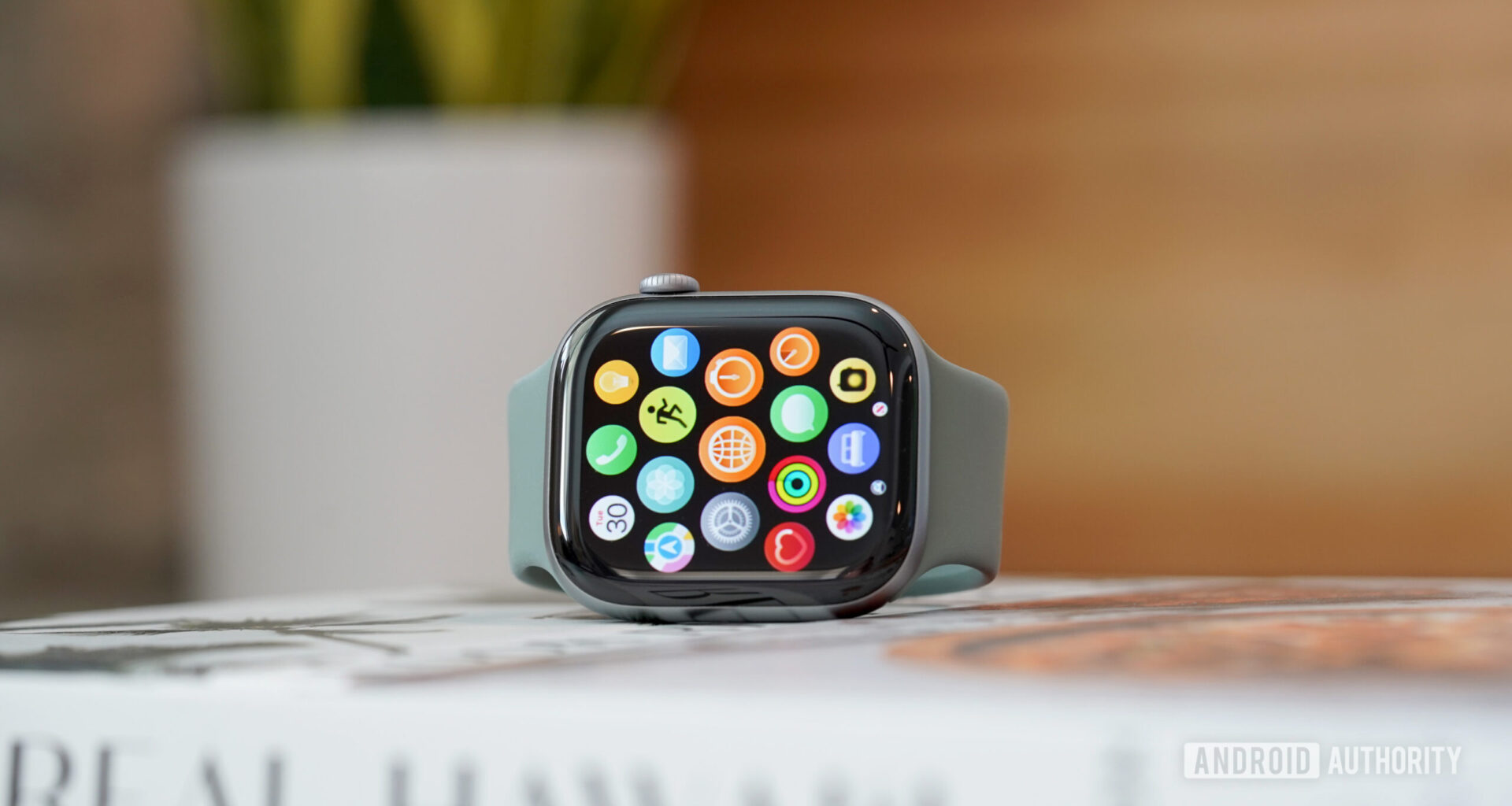 An Apple Watch Series 11 displays the updated app library.