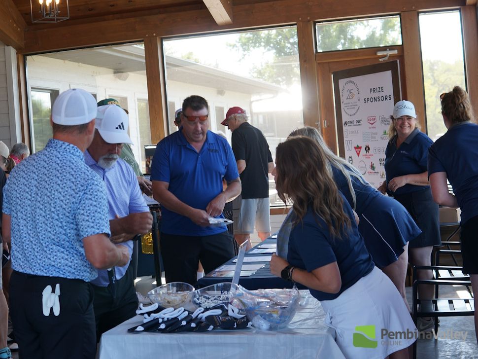 people collecting items on a patio during a golf tournament