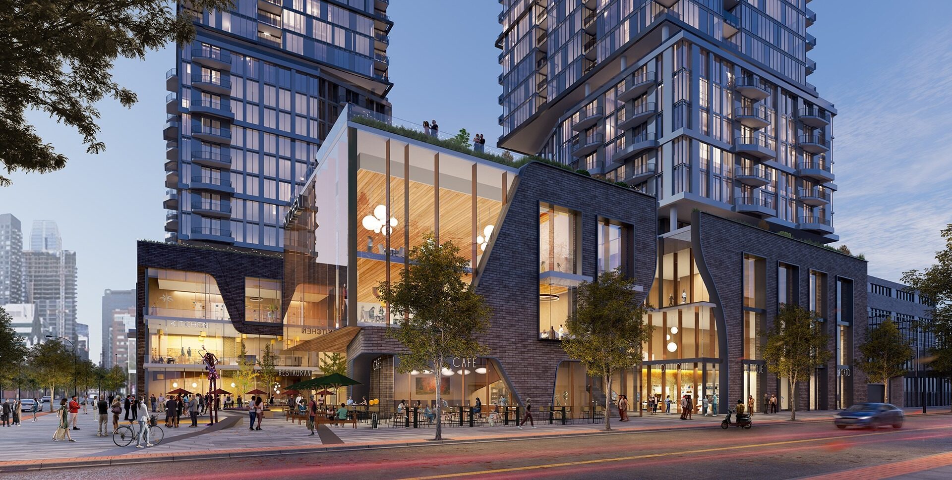 Modern architectural complex featuring glass and brick buildings with a plaza, people dining and walking, and a skyline backdrop.