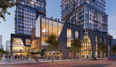 Modern architectural complex featuring glass and brick buildings with a plaza, people dining and walking, and a skyline backdrop.