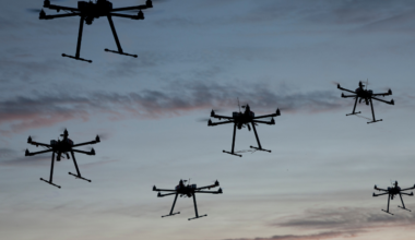 A fleet of drones at sunset