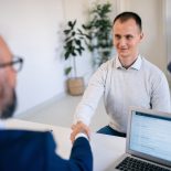 Male candidate handshake with the recruiter at job interview - stock photo