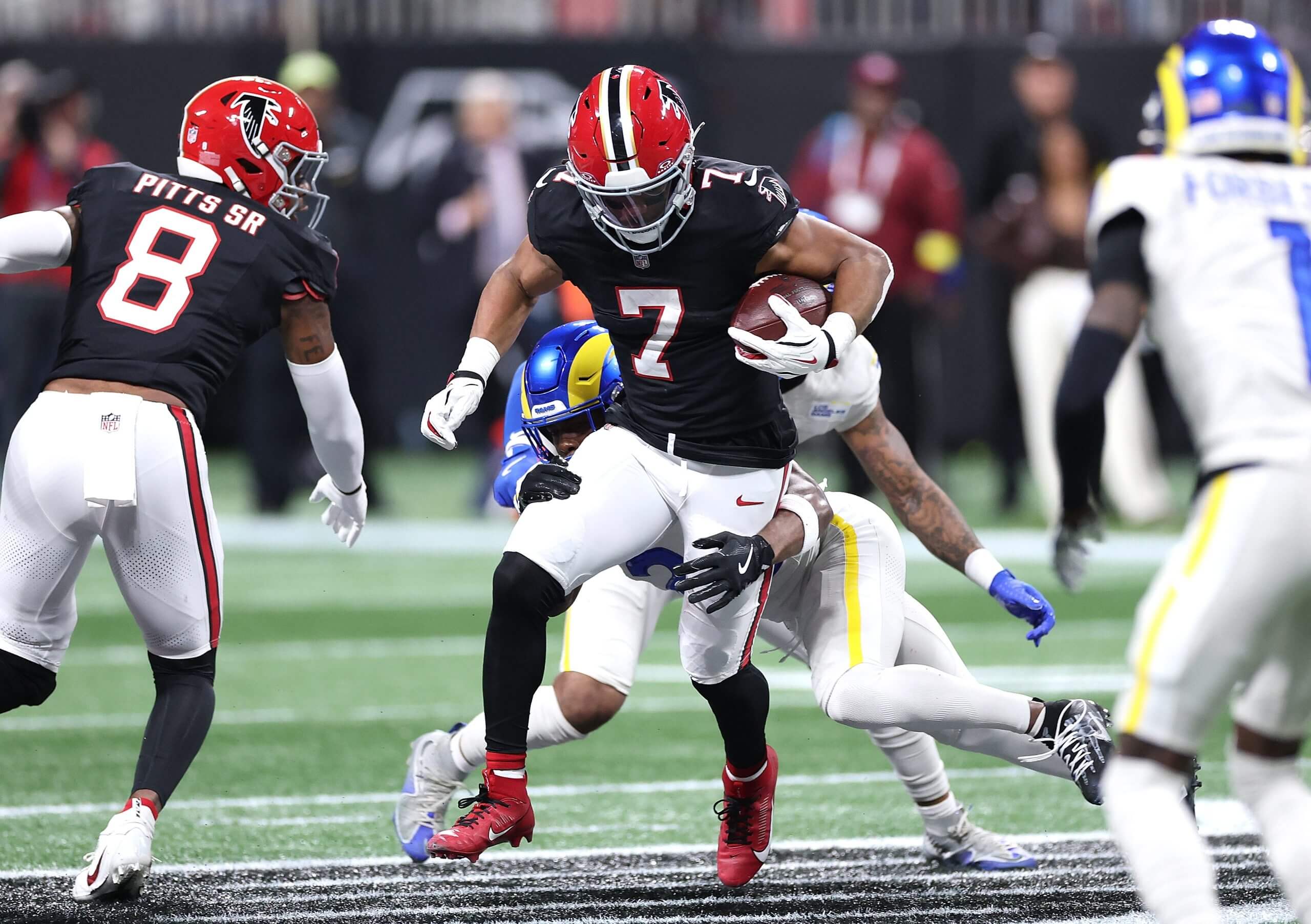 Bijan Robinson #7 of the Atlanta Falcons rushes against Kamren Kinchens #26 of the Los Angeles Rams during the second quarter at Mercedes-Benz Stadium on Dec. 29, 2025, in Atlanta.