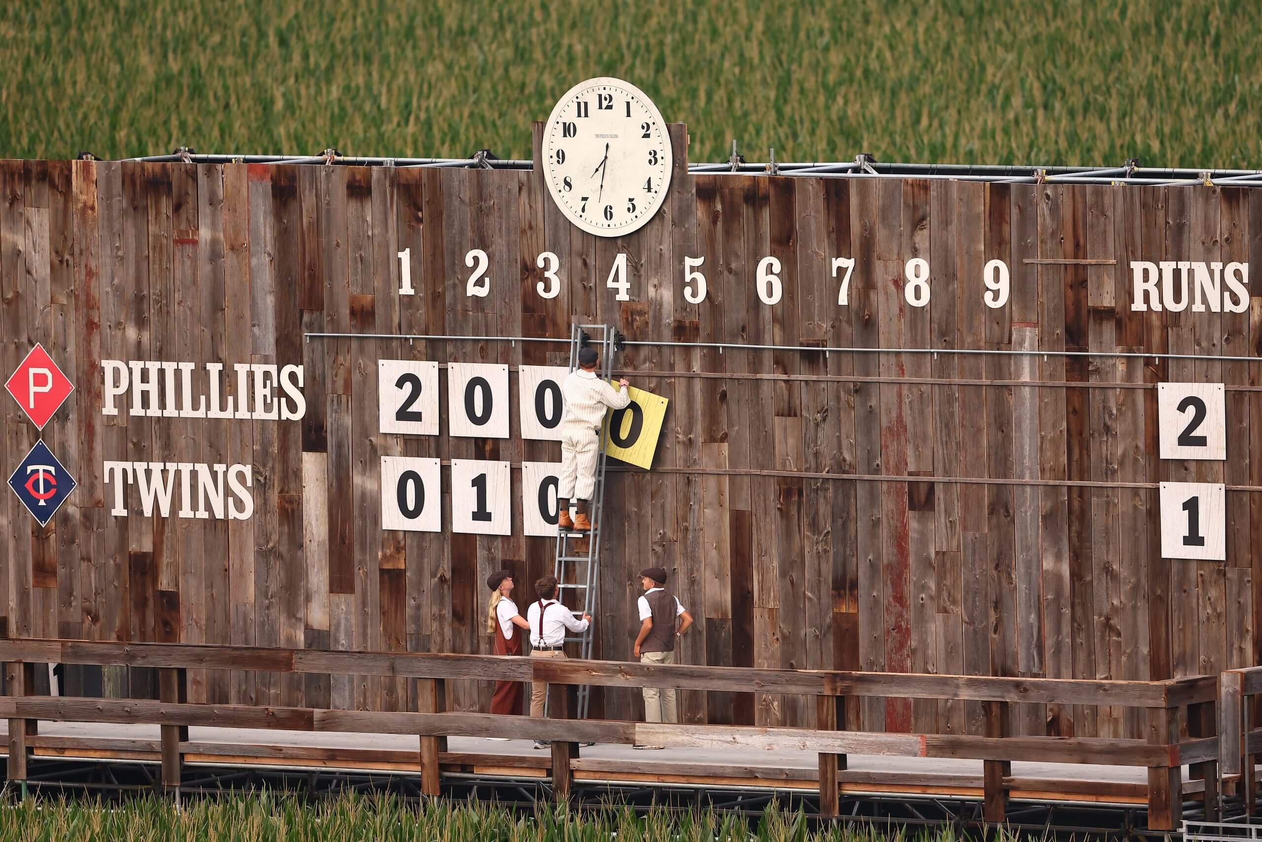 The manual scoreboard used for the Field of Dreams, which has a clock at its top, game is updated.