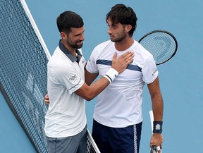 Novak Djokovic of Serbia hugs Thiago Agustín Tirante of Argentina after a match on day five of the Cincinnati Open at Lindner Family Tennis Center on August 15, 2026 in Mason, Ohio. (Emilee Chinn/Getty Images)
