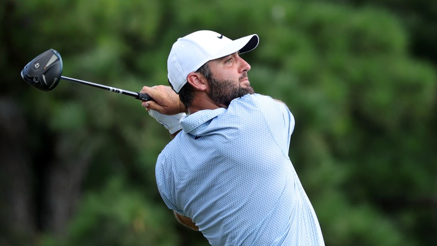 Golfer Scottie Scheffler swinging a club.