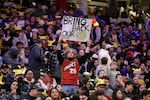 A fan holds a sign in the stands urging the former Seattle Sonics basketball team to return to Seattle before a preseason NBA basketball game between the Los Angeles Clippers and the Portland Trail Blazers, Friday, Oct. 11, 2024, in Seattle.