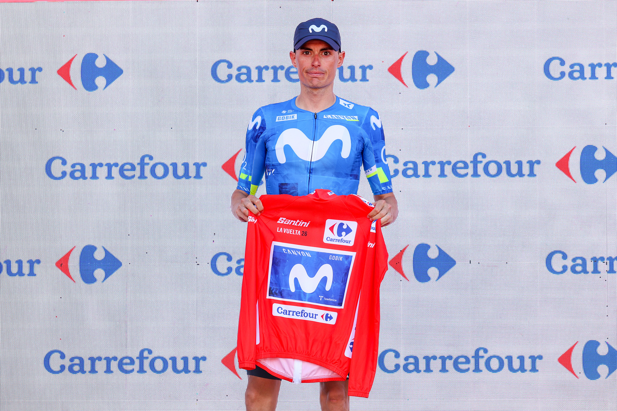 XERACO, SPAIN - AUGUST 29: Enric Mas of Spain and Movistar Team celebrates at podium as Red Leader Jersey winner without putting on a jersey as a sign of respect for the injured former leader Tadej Pogacar of Slovenia and UAE Team Emirates XRG, during the La Vuelta - 81st Tour of Spain 2026, Stage 8 a 171km stage from Pucol to Xeraco / #UCIWT / on August 29, 2026 in Xeraco, Spain. (Photo by Alexander Hassenstein/Getty Images)
