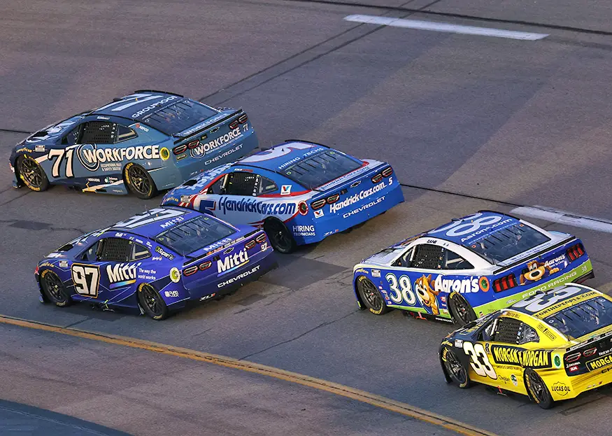 Shane van Gisbergen’s purple No. 97 Chevrolet races alongside Kyle Larson, Michael McDowell, Zane Smith and Austin Hill at Richmond Raceway.