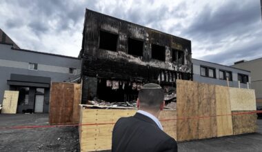 Man looks at burned-out restaurant.
