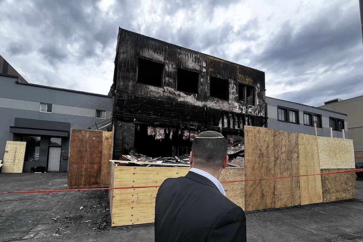 Man looks at burned-out restaurant.