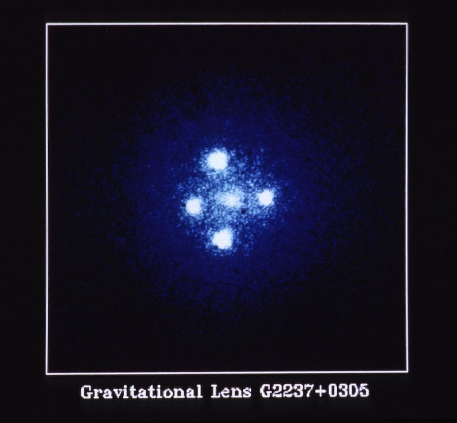 The Einstein Cross. Four images of a single quasar, split apart by the gravity of a galaxy twenty times closer to us. The diffuse glow at the centre is the lensing galaxy itself (Credit : NASA/ESA)