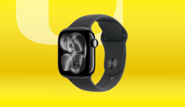 Black Apple Watch Series 11 against yellow CNET background