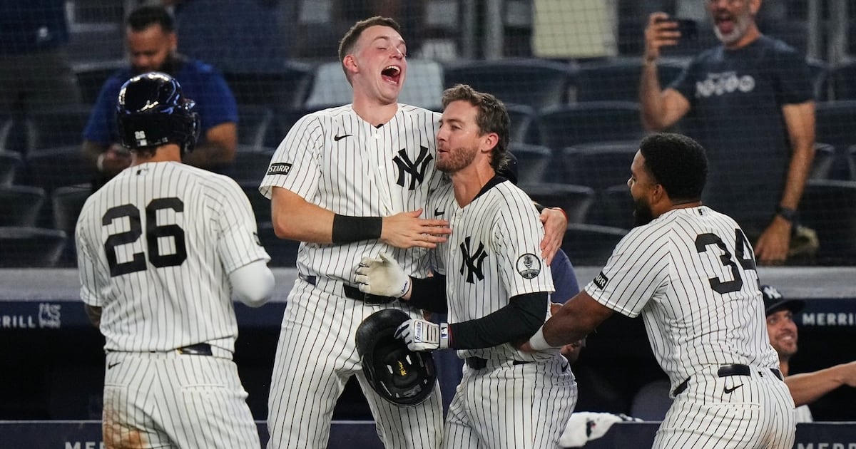 New York Yankees rally with 2 outs in 9th inning and beat Atlanta Braves in 10 after long rain delay