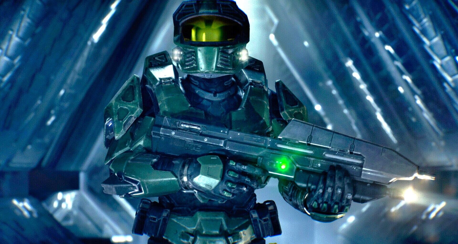 Master Chief wearing green tactical armor and a gold visor, holding a futuristic assault rifle inside a glowing blue geometric corridor structure.