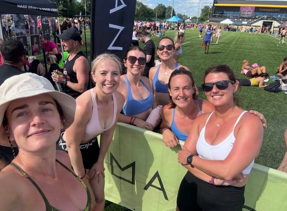 group of women smiling at an outdoor sports event on a sunny day. group of women smiling at an outdoor sports event on a sunny day.