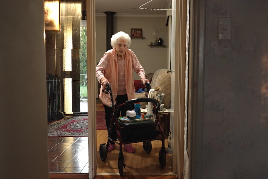 Audrey using a walker in a home.