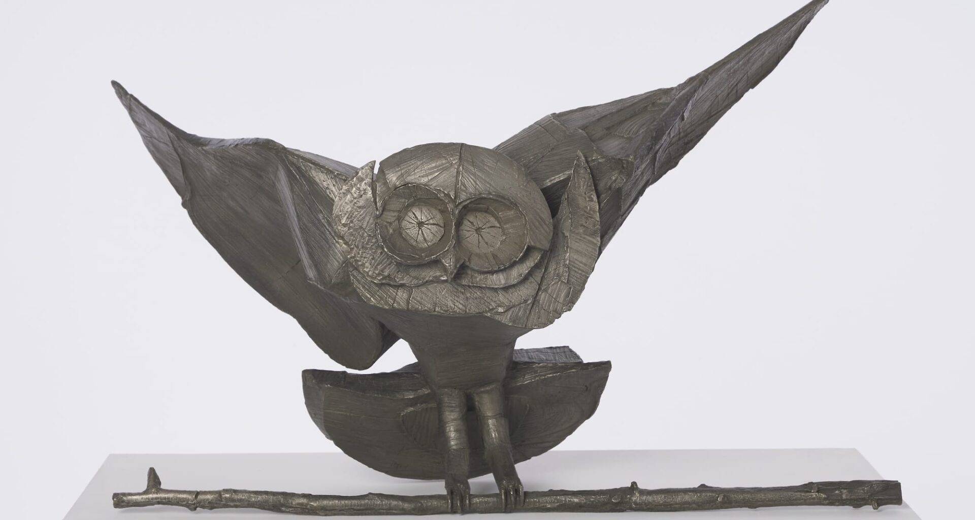 a bronze sculpture of a slightly cartoonish owl