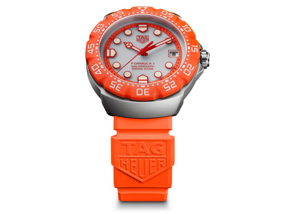 orange and silver sports watch with date display and tag heuer branding. orange and silver sports watch with date display and tag heuer branding.