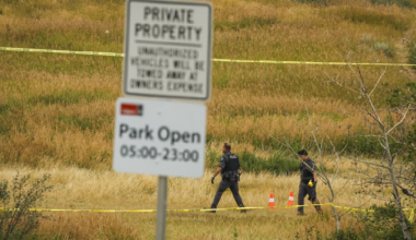 Calgary police officers look for evidence at the scene of an officer-involved shooting that took place near Edworthy Park in Calgary on Monday, Aug. 10, 2026.