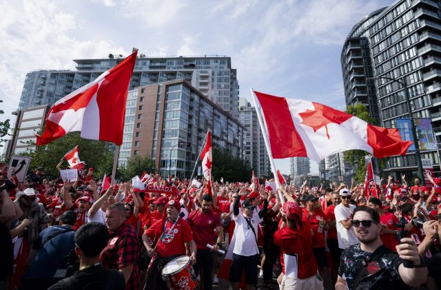 Canada fans march to B.C. Place stadium before Canada and Switzerland play a World Cup Group B soccer match, in Vancouver, on Wednesday, June 24, 2026. THE CANADIAN PRESS/Jacob Mallari