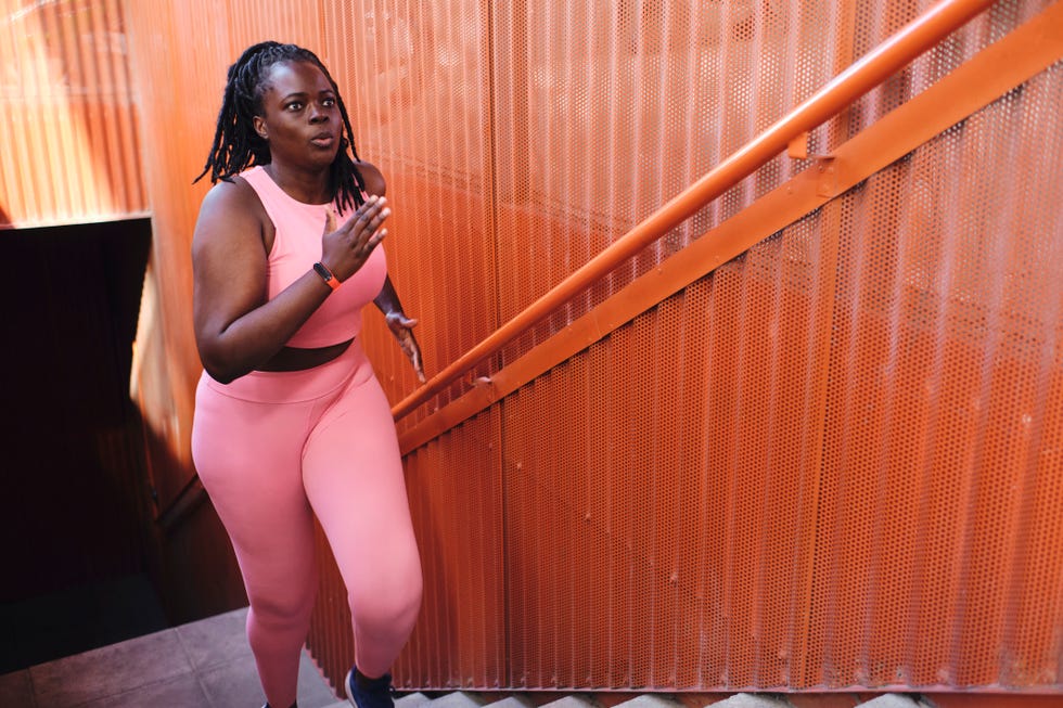 walking for fat loss: woman power walking up stairs